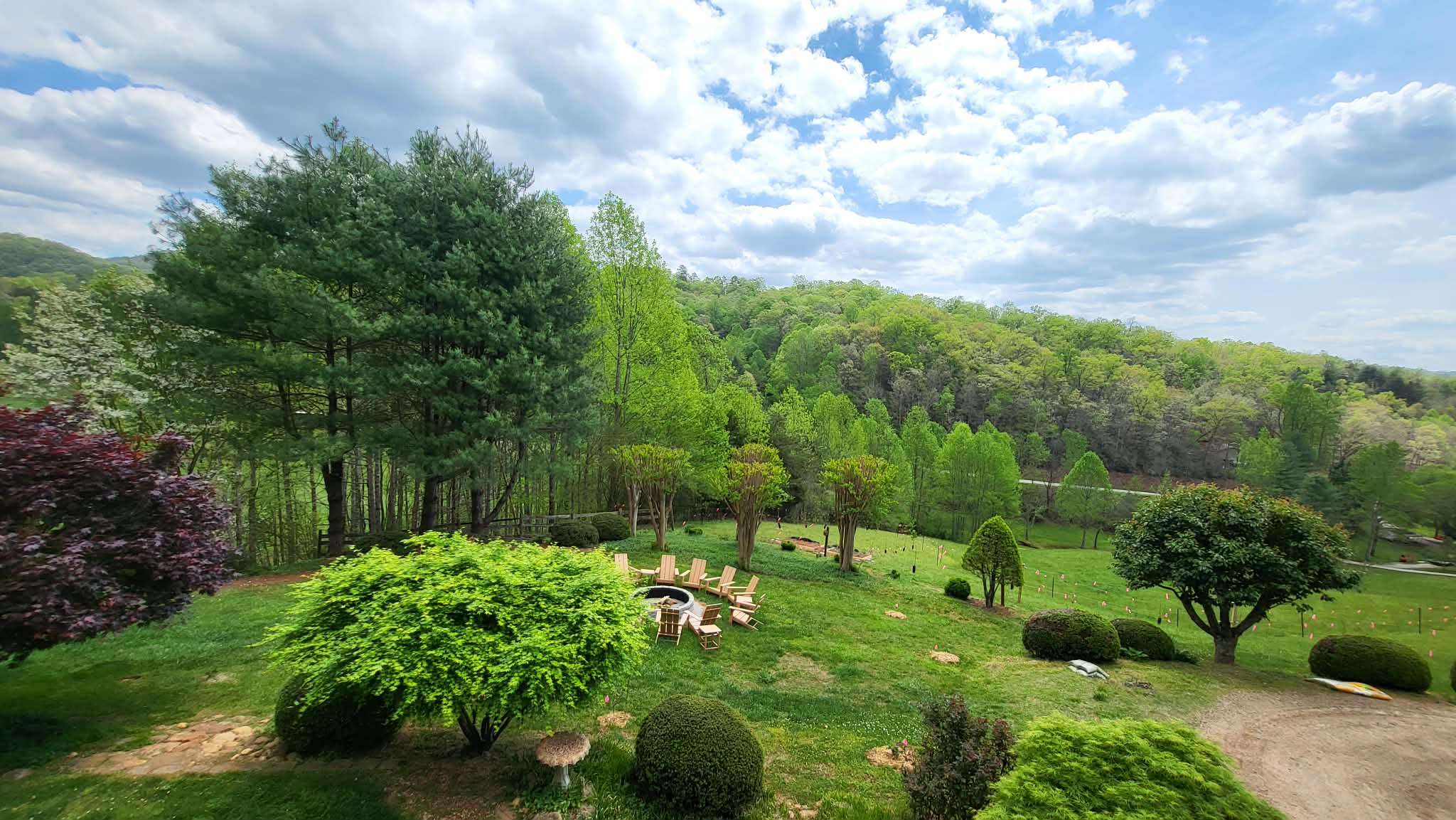 Fire pit area surrounded by landscaped gardens with mountain views