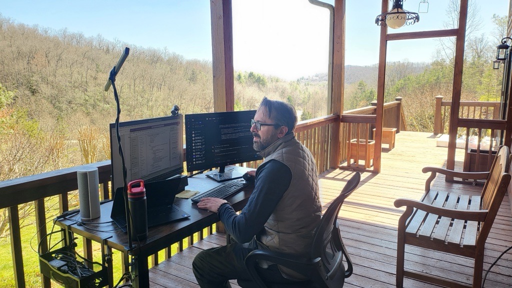 Rolling desk setup on the deck with mountain views