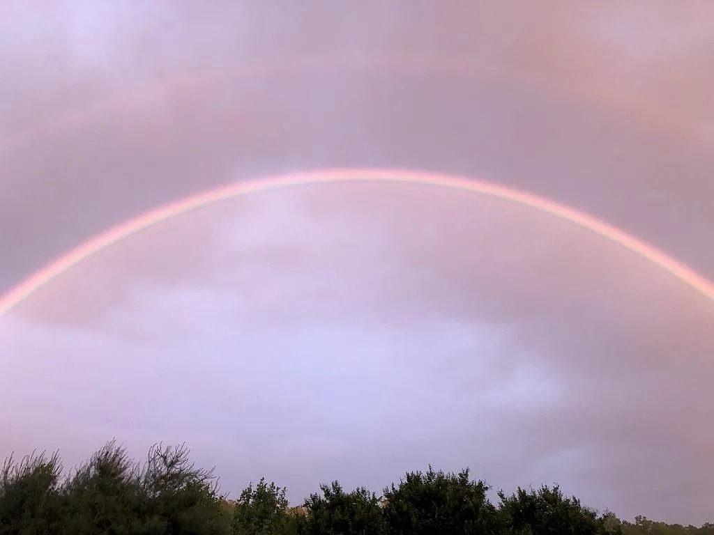 Rainbow arching over the Blue Ridge Mountains from the property
